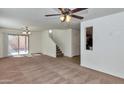 Spacious living room features neutral colored carpet, bright natural light, and modern ceiling fan at 3535 E Erie St, Gilbert, AZ 85295
