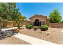 A single-story home with desert landscaping, stone accents, and an arched front window at 3715 S Skyline Dr, Gilbert, AZ 85297