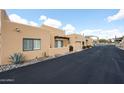 Tan stucco home featuring a private courtyard and desert landscaping at 37222 N Tom Darlington Dr # 15, Carefree, AZ 85377