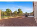 Large backyard featuring gravel, iron fencing, and a concrete patio area for outdoor enjoyment at 3865 E Dogwood Pl, Chandler, AZ 85286
