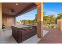 Relax on the spacious covered patio featuring a ceiling fan and private hot tub, great for outdoor living at 3865 E Dogwood Pl, Chandler, AZ 85286
