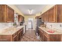 Spacious kitchen with ample countertops, wooden cabinets, and tile flooring at 421 S 113Th Way, Mesa, AZ 85208