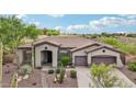 Charming single-story home with desert landscaping, mature trees, and a two-car garage at 42429 N Cross Timbers Ct, Anthem, AZ 85086