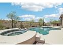 Inviting private pool and spa surrounded by desert landscape and mountain views at 42429 N Cross Timbers Ct, Anthem, AZ 85086
