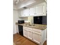 Well-lit kitchen with granite countertops, stainless steel sink, and white cabinets at 520 N Stapley Dr # 265, Mesa, AZ 85203
