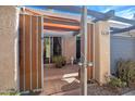 View through gated courtyard entrance to sliding glass doors and covered patio at 620 S Allred Dr, Tempe, AZ 85288