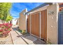 Inviting gated courtyard entrance with a secure wooden gate and mature plants at 620 S Allred Dr, Tempe, AZ 85288