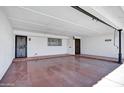 Spacious carport with two doors, tile flooring, and ample lighting, ready for vehicles and storage at 7632 E Bonita Dr, Scottsdale, AZ 85250