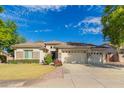 Charming single-story home with a three-car garage and well-maintained landscaping at 8664 W Yukon Dr, Peoria, AZ 85382
