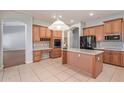 Spacious kitchen with an island, stainless steel appliances, and wood cabinetry at 8664 W Yukon Dr, Peoria, AZ 85382