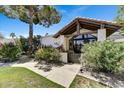 Inviting front entrance with lush landscaping, adding curb appeal and a sense of privacy to the home at 10157 E San Salvador Dr, Scottsdale, AZ 85258