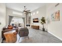 Bright living room featuring a stone fireplace and neutral-toned furnishings at 11260 N 92Nd St # 2054, Scottsdale, AZ 85260