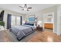 Inviting bedroom featuring hardwood floors, a comfy bed, side tables, and ensuite bathroom at 20121 N 76Th St # 2021, Scottsdale, AZ 85255