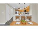 Modern kitchen with stainless steel appliances, bar seating, and a dining table with plates set at 20121 N 76Th St # 2021, Scottsdale, AZ 85255
