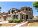 An angle view of a two-story home with decorative shutters, a well-manicured front yard, and unique architectural details at 2116 W Fawn Dr, Phoenix, AZ 85041