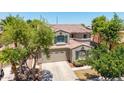 A stunning two-story home showing off the home's unique architectural features, attached garage, and front yard landscaping at 2116 W Fawn Dr, Phoenix, AZ 85041