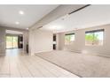 Bright and airy living room with tile flooring, plush carpet, and ample natural light at 2920 E Virginia E St, Mesa, AZ 85213