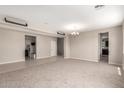 Spacious living room featuring neutral paint, carpet flooring, and modern lighting fixtures at 2920 E Virginia E St, Mesa, AZ 85213