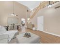 Spacious open-concept living and dining room with stylish decor and staircase at 29368 N Red Finch Dr, San Tan Valley, AZ 85143