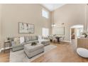 Bright, open-concept living and dining area with high ceilings and hardwood floors at 29368 N Red Finch Dr, San Tan Valley, AZ 85143