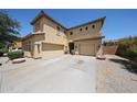 Beige two-story home with a tile roof, a three-car garage, and low-maintenance desert landscaping at 3088 E Andre Ave, Gilbert, AZ 85298