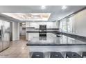 Modern kitchen featuring granite countertops, stainless steel appliances, and bright white cabinetry at 3102 W Betty Elyse Ln, Phoenix, AZ 85053