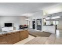 Spacious living room with vaulted ceilings, brick fireplace, and tile flooring, creating a cozy atmosphere at 3102 W Betty Elyse Ln, Phoenix, AZ 85053