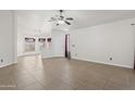 Bright, spacious living room featuring tile flooring and a ceiling fan at 3114 E Kristal Way, Phoenix, AZ 85050