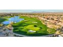 Breathtaking aerial view of the golf course community, showcasing the homes, lush greenery, water features, and mountain backdrop at 36172 N Secret Garden Path, Queen Creek, AZ 85140