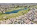 Gorgeous aerial view showcasing the community, lush golf course, scenic lake, and meticulously planned residential area at 36172 N Secret Garden Path, Queen Creek, AZ 85140