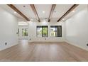 Bright living room features wood beam ceilings, large windows, and light wood flooring at 4278 E Del Rio Dr, San Tan Valley, AZ 85140