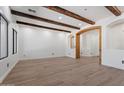 Spacious living room with exposed wood beams, neutral walls, and light wood flooring at 4278 E Del Rio Dr, San Tan Valley, AZ 85140