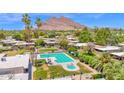 Aerial view of the neighborhood pool area, with grassy areas and desert landscaping at 4800 N 68Th St # 101, Scottsdale, AZ 85251
