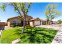 Inviting single-Gathering home with manicured lawn, mature tree, and attached two-car garage in a quiet neighborhood at 4837 E Whitehall Dr, San Tan Valley, AZ 85140