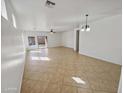 Spacious living area showcasing tile flooring, a ceiling fan, and abundant natural light from multiple windows at 5339 W Maldonado Rd, Laveen, AZ 85339