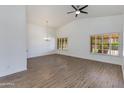 Bright, airy living room featuring vaulted ceilings, fan, and wood-look flooring at 5507 E Kings Ave, Scottsdale, AZ 85254