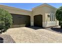 Exterior featuring a two-car garage and well-manicured landscaping at 562 E Vesper Trl, Queen Creek, AZ 85140