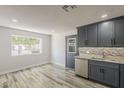 Bright kitchen with stainless steel appliances, granite counters, and a view to the spacious backyard at 662 W Elena Ave, Mesa, AZ 85210