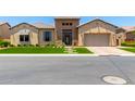 Inviting exterior featuring manicured front yard, stone accents, and well-maintained landscaping at 7002 S Portland Ave, Gilbert, AZ 85298