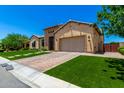 Well-maintained home with artificial lawn, brick driveway, and attached two-car garage at 7002 S Portland Ave, Gilbert, AZ 85298