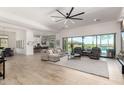 Open living space featuring modern ceiling fan, tile floors, and backyard pool views at 7002 S Portland Ave, Gilbert, AZ 85298