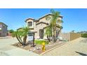 Traditional two-story home featuring a three-car garage, desert landscaping, and a charming front entrance at 7398 W Paso Trl, Peoria, AZ 85383