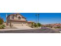 Attractive two-story home featuring a three car garage and mature desert landscaping at 818 E Hiddenview Dr, Phoenix, AZ 85048