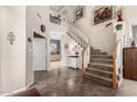 Open foyer with a staircase, high ceilings, and access to a powder room at 818 E Hiddenview Dr, Phoenix, AZ 85048
