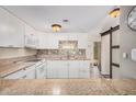 Well-lit kitchen offers white cabinetry, granite countertops, and stainless-steel appliances at 8210 E Garfield St # K23, Scottsdale, AZ 85257