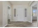 Inviting foyer with natural light, neutral paint, and durable floors leading into the home at 8620 W Denton Ln, Glendale, AZ 85305