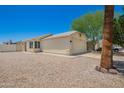 This exterior shot showcases the front of the house, the two car garage, and the gravel landscaping at 8835 W John Cabot Rd, Peoria, AZ 85382