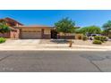 Charming single-story home with a well-maintained front yard and a two-car garage at 11249 N 161St Ave, Surprise, AZ 85379