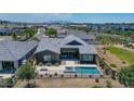 Stunning aerial view of home with pool, spa, outdoor space, and beautiful desert landscaping at 11534 N Jerome St, Surprise, AZ 85388
