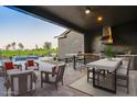 Beautiful outdoor covered patio and kitchen with seating for outdoor entertaining at 11534 N Jerome St, Surprise, AZ 85388